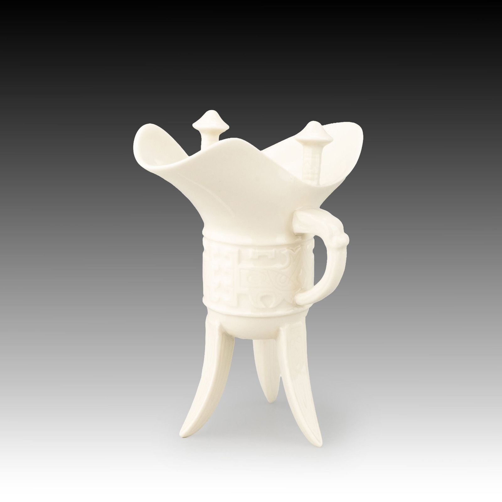 White Porcelain Jue by Kato Minoru, Tomobako: Inspired by the ancient Chinese bronze jue wine vessel, this elegant white porcelain work by Kato Minoru presents a refined interpretation of one of East Asia's most iconic ritual forms.The vessel fai