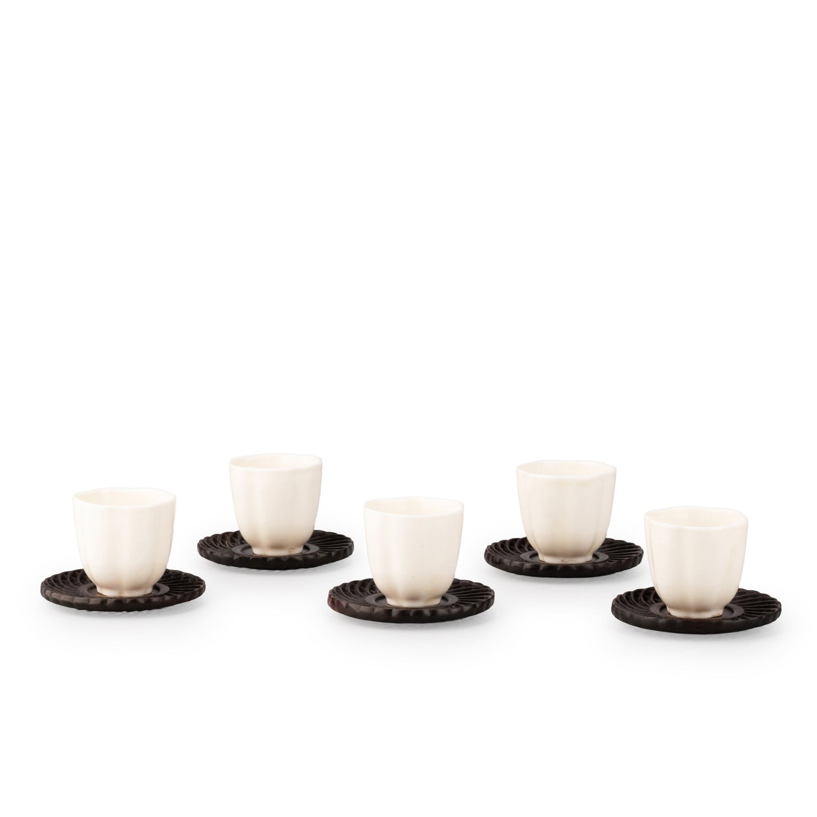 Set of Five Bowls with Saucers: This elegant set comprises five Dehua white porcelain tea cups accompanied by matching carved wooden saucers. Each cup is finely potted with a gently flared rim, softly rounded body, and neatly finish