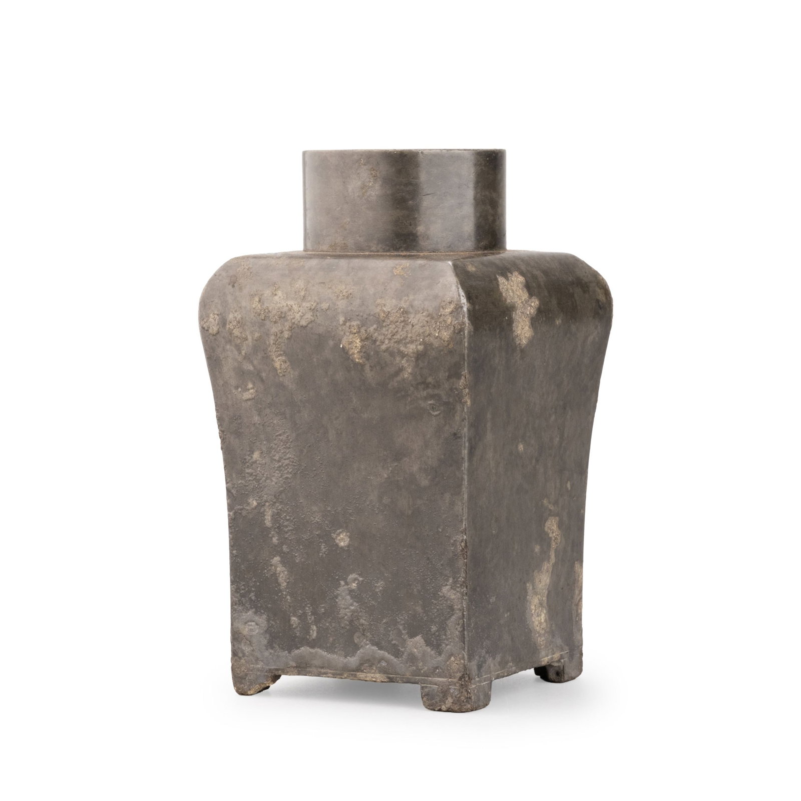 Pewter Tea Caddy: This pewter tea caddy is of restrained square form, rising from four short feet to a gently rounded shoulder and a cylindrical fitted cover. Its clean architectural profile reflects the understated el