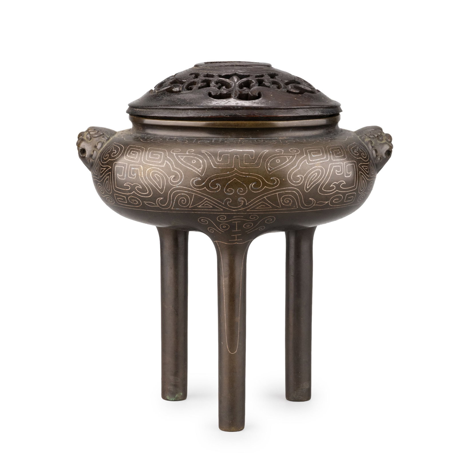 Silver-Inlaid Bronze Koro by Sekiso: This elegant bronze incense burner by Sekiso features a compressed globular body raised on three tall legs, flanked by finely modeled lion-mask handles and fitted with an openwork cover. The vessel is