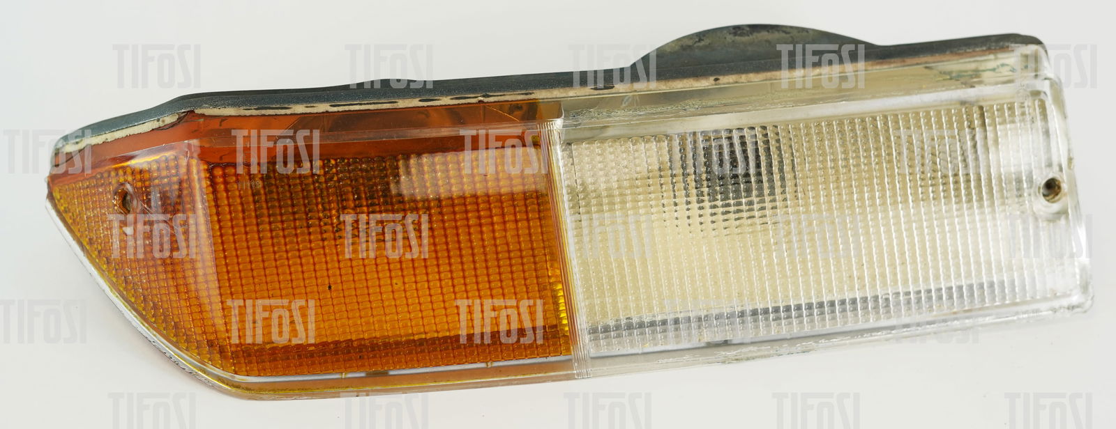 Ferrari 400 412 Headlamp Unit: A left-hand Ferrari 400/412 headlamp unit by Carello. Used condition, some small scracks to the lens.