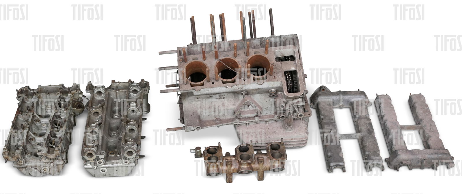 Fiat Dino 2000 Engine: A partially complete Fiat Dino 2000 engine. The block is cracked. Also included are a pair of heads, cam covers, crankshaft and inlet manifold.