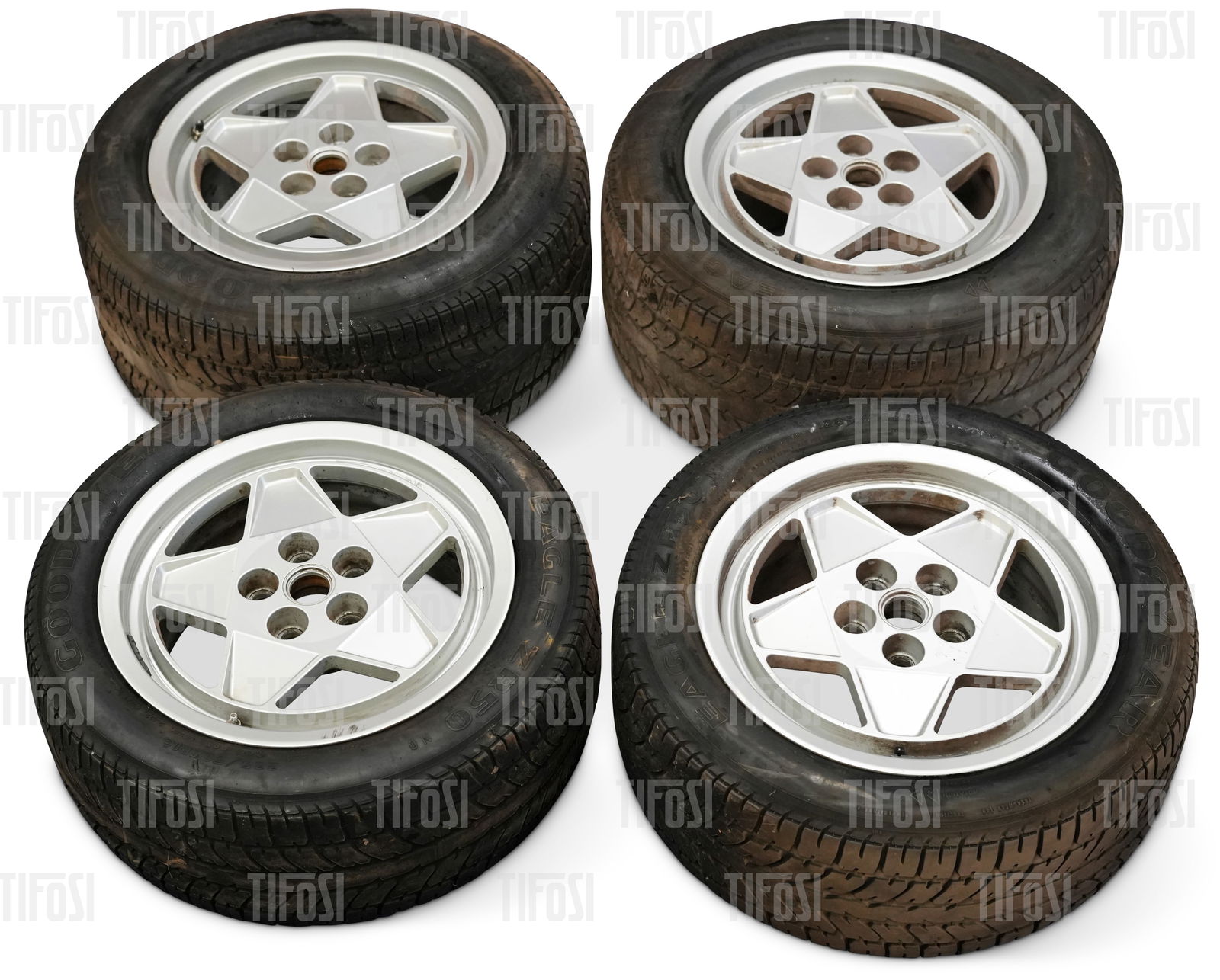 Ferrari Testarossa Speedline Wheel Set: A set of original Ferrari Testarossa wheels by Speedline. In good used contiion, one with a small area of kerb damage, still shod with Goodyear Eagle tyres. All wheels are dated 1990.