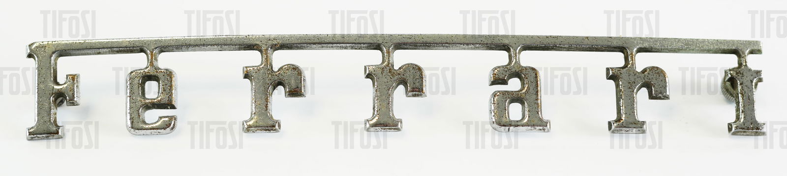 Ferrari Script Badge: A used original chrome plated metal Ferrari script badge, 20CM length.