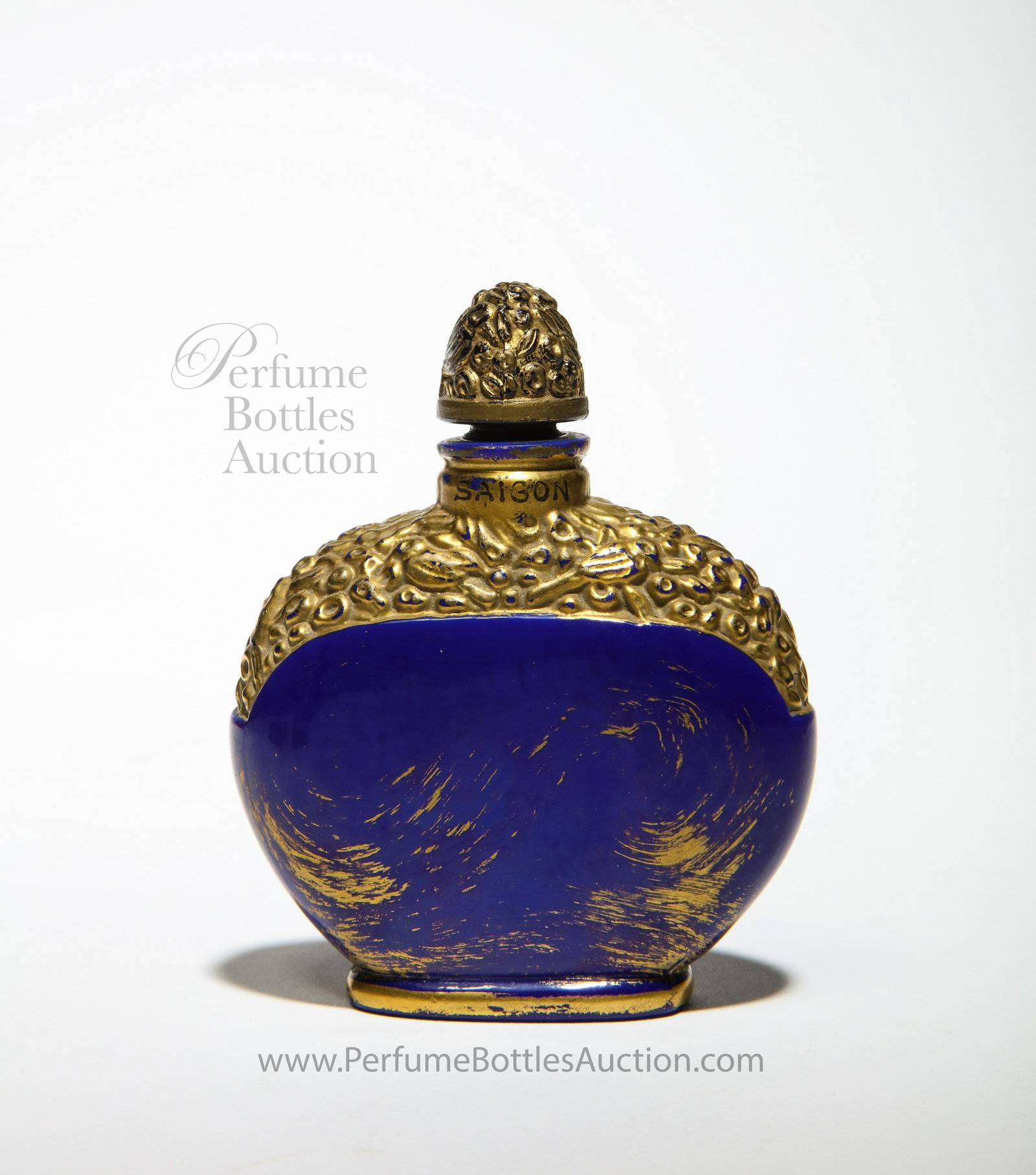 1925 Jollivet Art Deco Perfume Bottle for Babani Saigon: 1925 A. Jollivet for Babani Saigon perfume bottle and stopper, opaque blue glass imitating lapis lazuli, gilt detail, enameled labeling. 3 3/8 in.