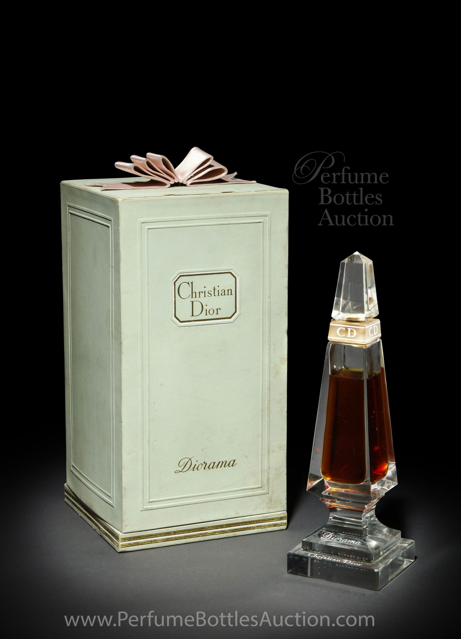 1954 Baccarat Perfume Bottle for Christian Dior Diorama: 1954 Baccarat design for Christian Dior Diorama clear crystal perfume bottle and stopper, frost collar segment, enameled labeling. Â“Dressing mirrorÂ” box. 8 1/8 in. *Bottle was filled for photo