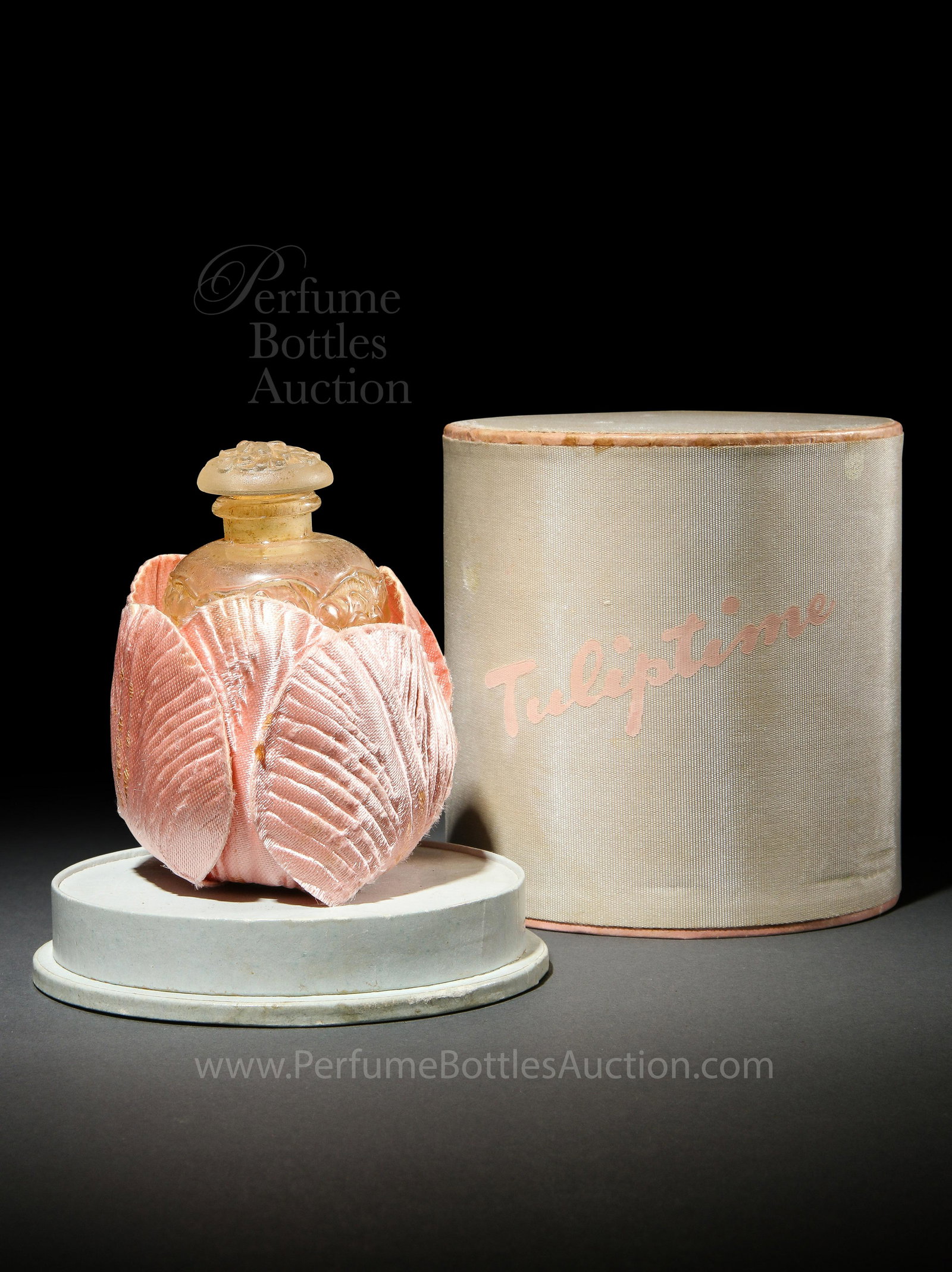 1940 Viard Perfume Bottle for Harriet Hubbard Ayer: 1940 J. Viard for Harriet Hubbard Ayer Tulip Time clear/frost perfume bottle and stopper, embossed flower blossom motif, silk flower holder, fabric box. 2 1/4 in.