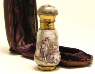 18th c. Watteau Enamel Vinegarette Scent Bottle: 18th c. Vinegarette/scent bottle in enamel after paintings by Watteau, with gilt metal pressure cap, the foot concealing a vinegarette with hinged screen. With box (seperated hinge). Marked Hunt&Roske