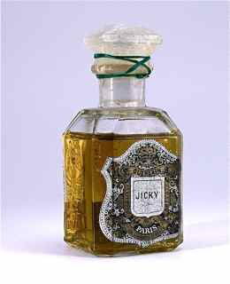 1910s Guerlain Perfume Bottle for "Jicky": 1910s Guerlain perfume bottle for "Jicky" in clear glass, embossed labeling, sealed, paper label. 4 in.