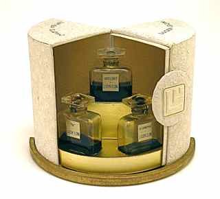 1940s Lucien Lelong Perfume Sampler Set: 1940s Perfume sampler for Lucien Lelong "Indiscret", "N", "Passionnement" of three bottles in clear glass with labels, sealed, in animated box with embossed lace texture. 2 1/4 in.