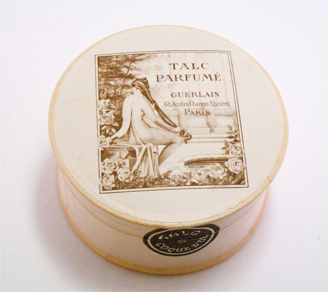 1940 Guerlain Talc Coque D'Or Powder Box: 1940 Guerlain Talc Coque D'Or powder box, beige paper, sepia graphic of a bathing scene signed J. Cantel, sealed contents. Diam. 3 3/4 in.