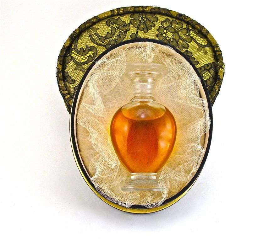 1949 Lalique - Rochas Mousseline Perfume Bottle: 1949 Lalique, Rochas Mousseline perfume bottle and stopper, clear crystal, label, tied in lace covered yellow box, outer box. Lalique mark. Limited edition. 4 1/2 in