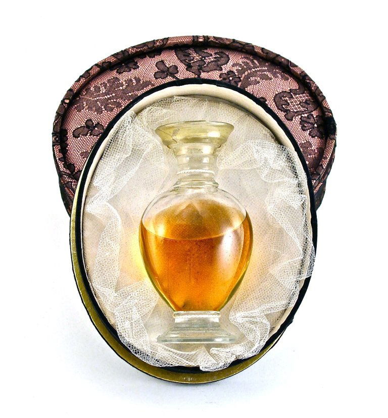 1949 Lalique - Rochas Perfume Bottle: 1949 Lalique, Rochas perfume bottle and stopper, clear crystal, lacking label, tied in lace covered pink box, outer box. Lalique mark. Limited edition. 4 1/2 in