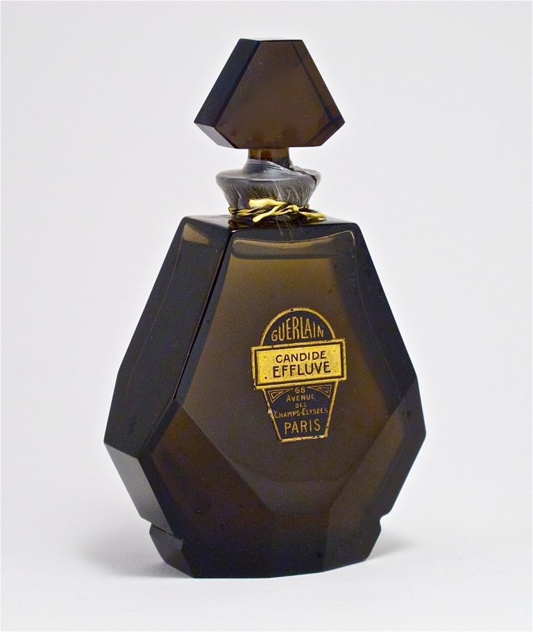 1924 Baccarat - Guerlain Candide Effluve Bottle: 1924 Baccarat, Guerlain Candide Effluve perfume bottle and stopper, smoke grey crystal, cord seal, label. Baccarat mark. 5 in.