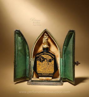 Benoit "Merry Christmas" perfume bottle with gilded nativity scene and stopper as Madonna and Child: 1927 Depinoix design and manufacture for Benoit Merry Christmas, black glass perfume bottle, large gilt label depicts nativity scene, gilt figural stopper, mother and child. Rarely seen leather box, g