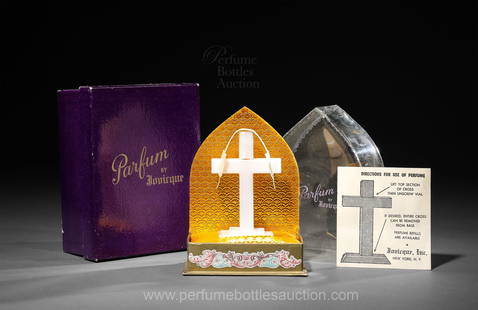 1945 Perfume presentation for Jovicque Parfum, novelty bottle as a plastic cross: 1945 Perfume presentation for Jovicque Parfum, lower section of plastic cross holds bottle, screw cap in top section, acetate cover. Box, with use directions. 6 in.