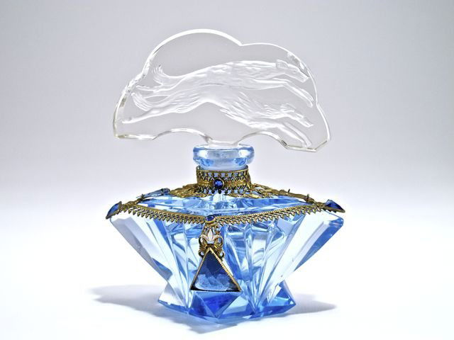 1920s Czechoslovakian perfume bottle, blue crystal, cle: 1920s Czechoslovakian perfume bottle, blue crystal, clear double intaglio stopper (dauber), enameled jeweled metalwork. Lacking one shoulder jewel. Small inner flaw over upper dog head. Made in Czecho