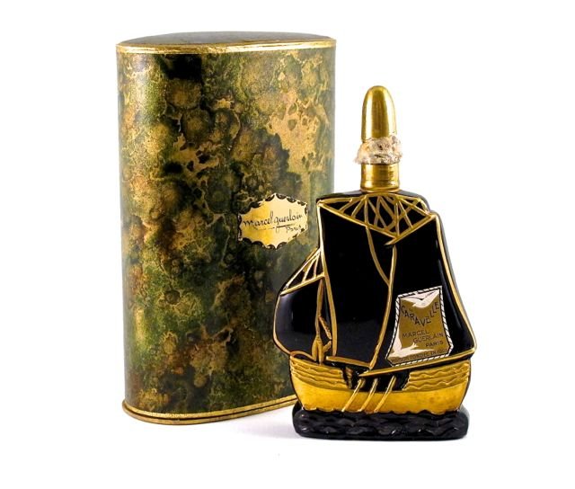 1924 Depinoix, Marcel Guerlain Caravelle figural perfum: 1924 Depinoix, Marcel Guerlain Caravelle figural perfume bottle and stopper, black glass, gold and silver gilt details, label, cord sealed, seldom seen box. 5 1/2 in.