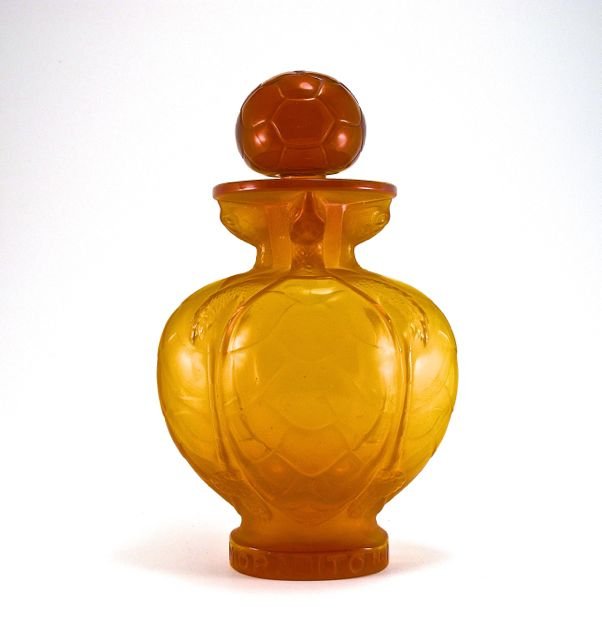 1951 Marc Lalique, Morabito No. 7 perfume bottle and st: 1951 Marc Lalique, Morabito No. 7 perfume bottle and stopper, opalescent butterscotch crystal, molded labeling. Lalique mark. Molded as 4 turtles for the Place Vendome luxury store. 8 3/4 in.