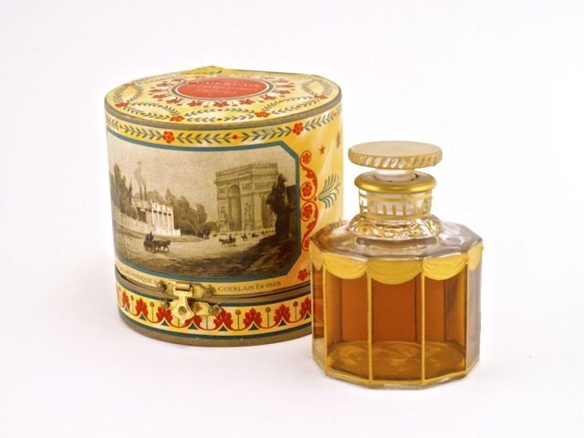 1906 Guerlain Apres L’Ondee perfume bottle and stopper,: 1906 Guerlain Apres L’Ondee perfume bottle and stopper, clear glass, gilt detail (tiny loss in drape-visible in photo), label, box (split hinge). 3 in.