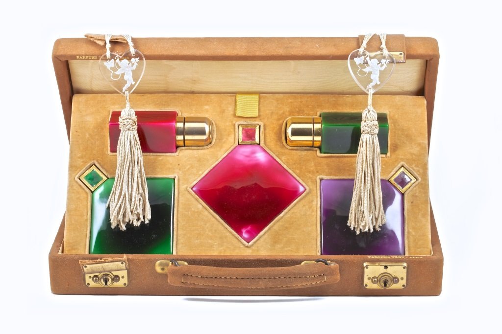 1930s Baccarat,Ybry 5 Perfume Bottle Gift Set: 1930s Baccarat,Ybry deluxe gift set, 3 perfume bottles (w/inner stoppers), and 2 atomizers, of green, pink and purple cased crystal, metal fittings, and caps with enamel. Suede case marked Ybry, leath