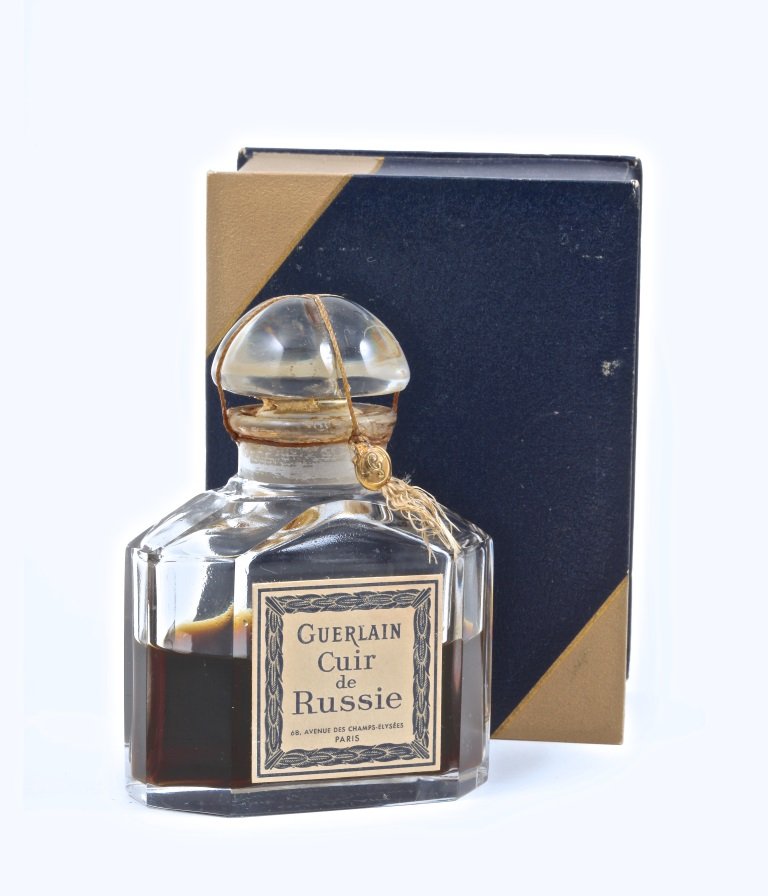 c1930 Baccarat Guerlain Cuir de Russie Perfume Bottle: c1930 Baccarat, Guerlain Cuir de Russie perfume bottle and stopper, clear crystal, cord seal, label, box. Baccarat mark. 3 3/4 in.