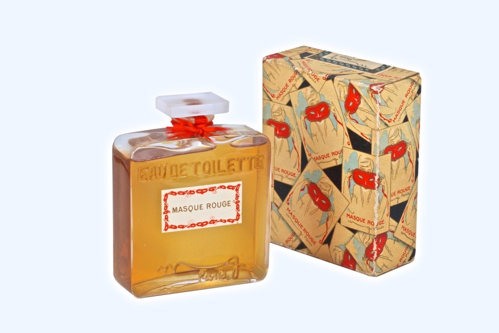 1920s M. Guerlain Masque Rouge Bottle: 1920s Marcel Guerlain Masque Rouge eau de toilette bottle and stopper, clear/frost glass, molded and 2 paper labels, cord seal, box with red mask graphics. 3 1/2 in.