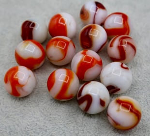 A grouping of Red & White Agate Swirl Marbles
