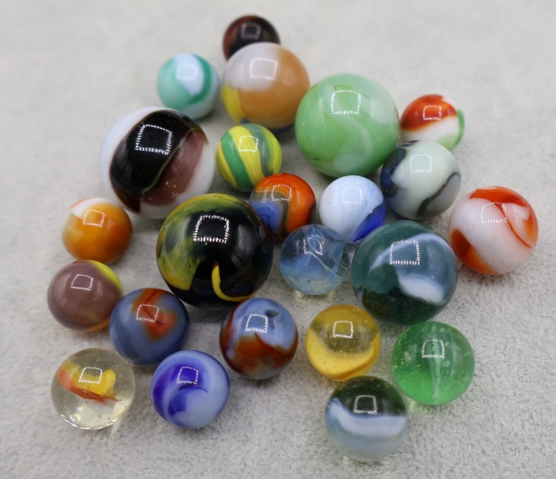 A Grouping of Various Vintage Marbles: Various makers. Various Types like swirl, agate, flame and patch. Various conditions. A variety of vintage marbles from a lifelong collection. Lot 38