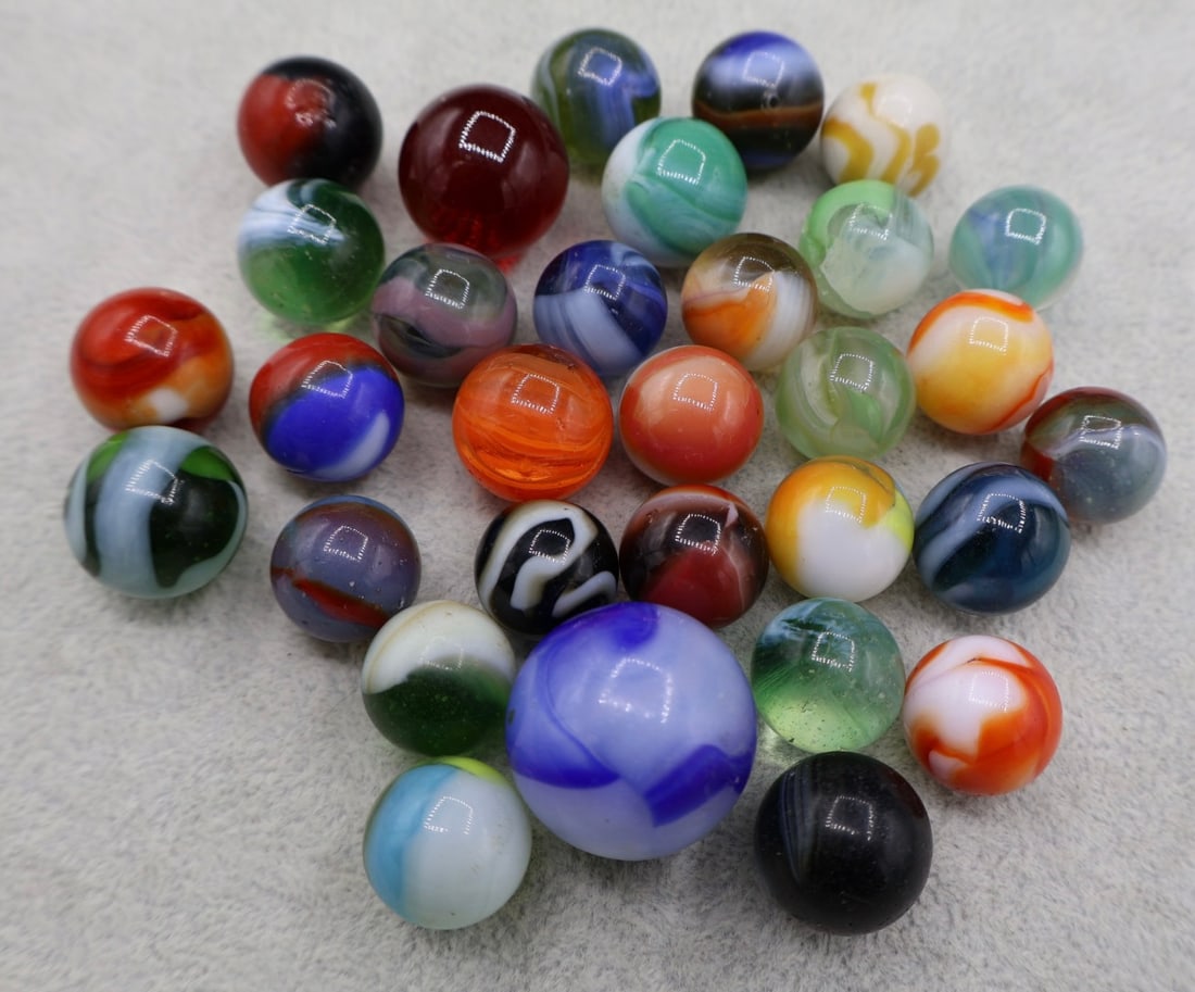 A Grouping of Various Vintage Marbles: Various makers. Various Types like swirl, agate, flame and patch. Various conditions. A variety of vintage marbles from a lifelong collection. Lot 44