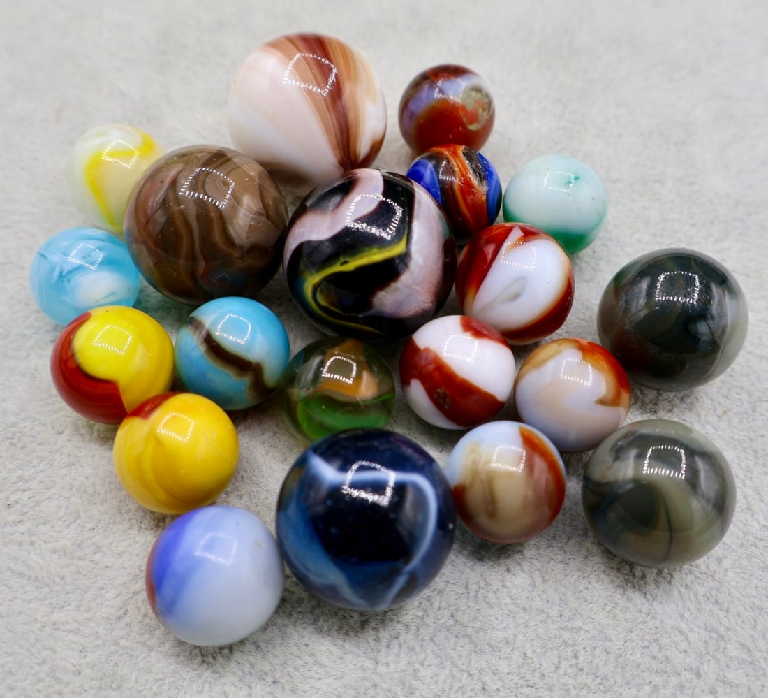 A Grouping of Various Vintage Marbles: Various makers. Various Types like swirl, agate, flame and patch. Various conditions. A variety of vintage marbles from a lifelong collection. Lot 46