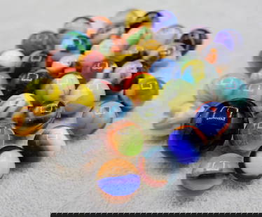 A Grouping of Various Vintage Marbles: Various makers. Various Types like swirl, agate, flame and patch. Various conditions. A variety of vintage marbles from a lifelong collection. Average size 5/8&rdquo;. Lot 56