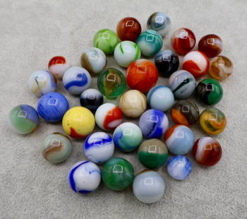 A Grouping of Various Vintage Marbles: Various makers. Various Types like swirl, agate, flame and patch. Various conditions. A variety of vintage marbles from a lifelong collection. Average size 5/8&rdquo; to 3/4&rdquo;. Lot 62