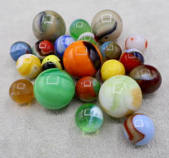A Grouping of Various Vintage Marbles: Various makers. Various Types like swirl, agate, flame and patch. Various conditions. A variety of vintage marbles from a lifelong collection. Average size 5/8&rdquo; to 1&rdquo;. Lot 63