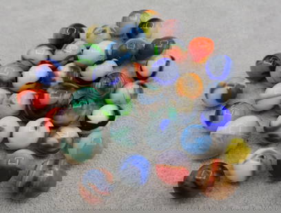 A Grouping of Various Vintage Marbles: Various makers. Various Types like swirl, agate, flame and patch. Various conditions. A variety of vintage marbles from a lifelong collection. Average size 5/8&rdquo; to 1&rdquo;. Lot 64