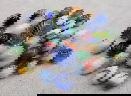 A Grouping of Various Vintage Marbles: Various makers. Various Types like swirl, agate, flame and patch. Various conditions. A variety of vintage marbles from a lifelong collection. Average size 5/8&rdquo; to 1&rdquo;. Lot 65