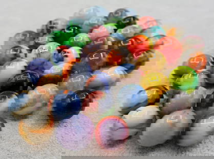 A Grouping of Various Vintage Marbles: Various makers. Various Types like swirl, agate, flame and patch. Various conditions. A variety of vintage marbles from a lifelong collection. Average size 5/8&rdquo;&rdquo;. Lot 66