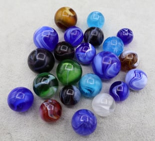 A handful of Antique Slag Glass Marbles