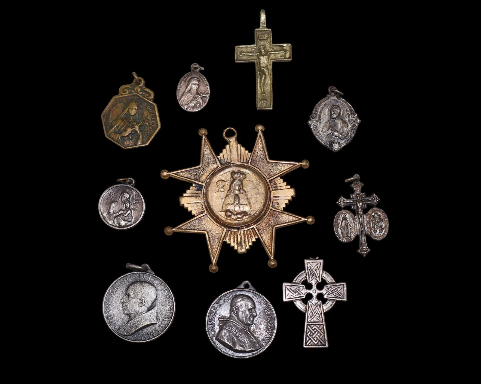 A Collection of Antique Religious Medals: Catholic Medals. Worn as pendants for protection. A variety of different types. At least one is sterling silver.