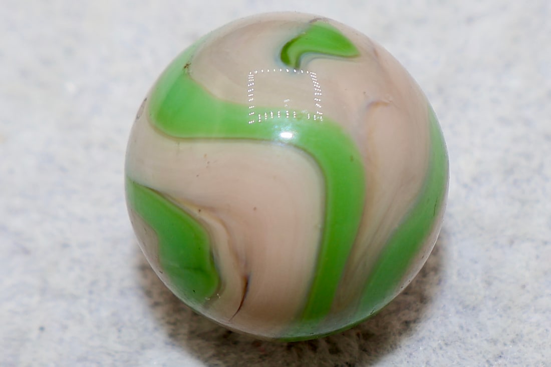 Very Nice Ravenswood Green Fleshtone Swirl Marble: Very nice Ravenswood swirl marble with beautiful lime green swirls against fleshtone base. 5/8”.