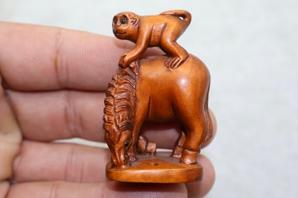 A Finely Carved Japanese Boxwood Monkey Riding Horse Netsuke