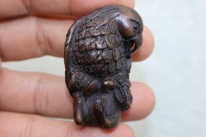 A Finely Carved Japanese Dark Boxwood Eagle Hunting Monkey Netsuke