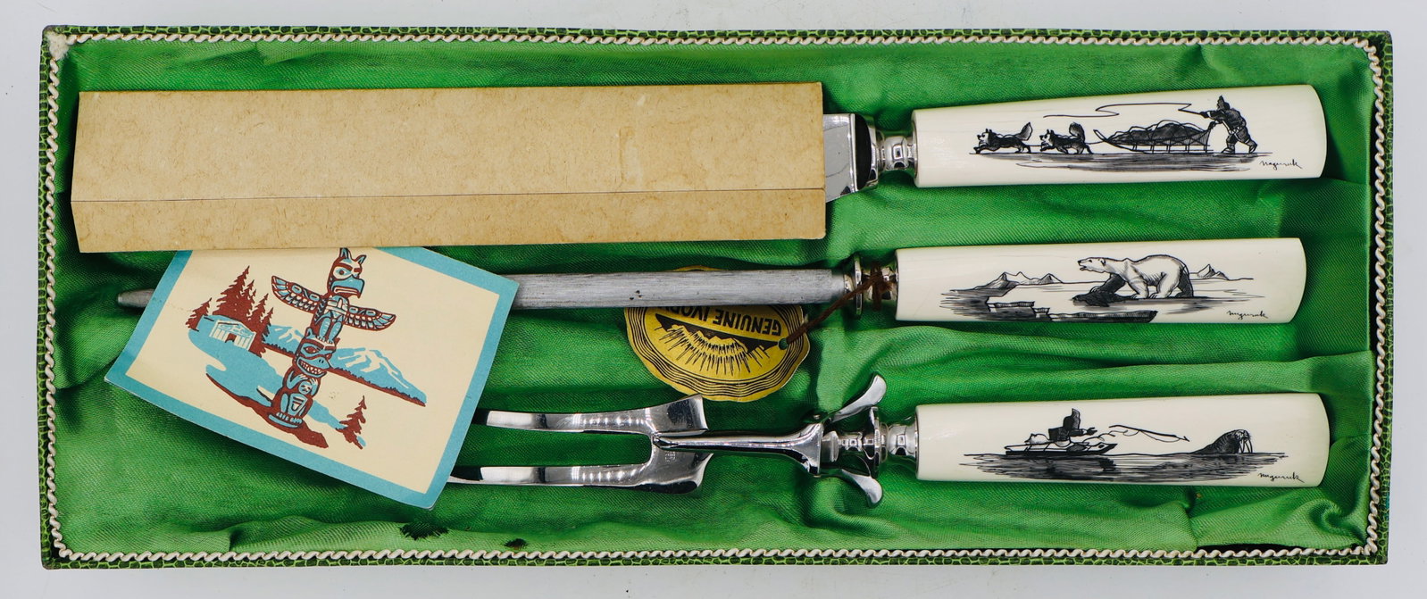 A Vintage Inuit Carved & Scrimshawed Cutlery Set: A very nice scrimshaw cutlery set featuring three scenes of Inuit life. All have very nice detailing and are very well done. Signed. Vintage; Brand new in the box.