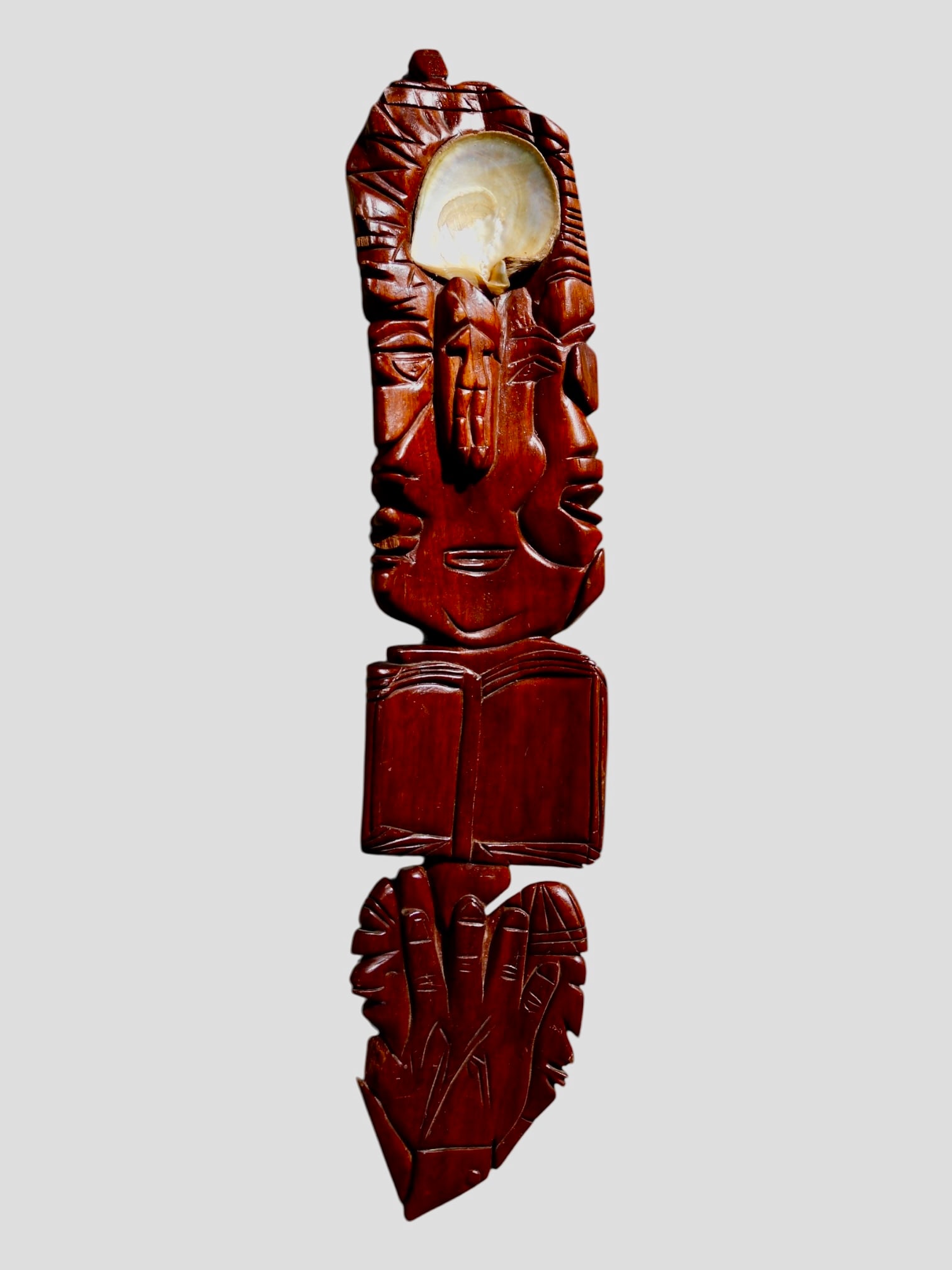 An Oceanic Totem Wooden Janus Panel Carving: 20th C. Rapa Nui. Featuring a large abalone shell adornment with multiple faces and totemic symbolism. A beautiful piece of tribal art from a hard to acquire locality.