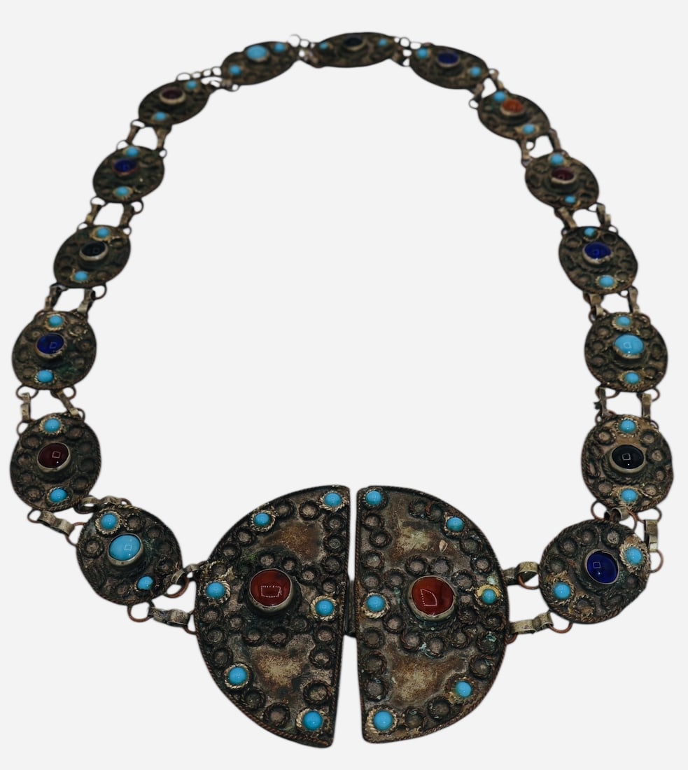 A Vintage Nepalese Hammered Metal Belt: Mid 20th Century Nepal Ethnic Art. Hand hammered with metal circular accents and glass and stone inlays.