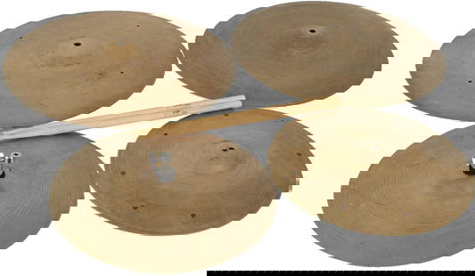Four Cymbals, Snare Drum, Two Drumsticks and Two Wire Brushes: Four gold cymbals. Two "The Super Zyn", made in England, 14" across. Two large 18" across, unbranded. One Remo Weatherking Ambassador Snare drum. Two Johnny Brooks drumsticks and two wire brushes. Wei