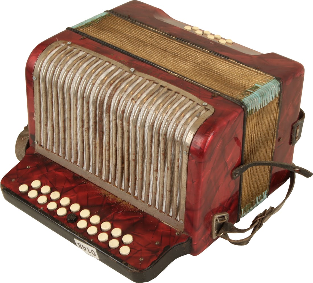 Hohner Double Ray de Luxe Accordion: 11 treble buttons, 4 bass. Red mother of pearl finish. Comes with leather straps. Made in Germany. Weight 4.1kg. Some rust to grille, netting under grille has come partially undone, bellows slightly u