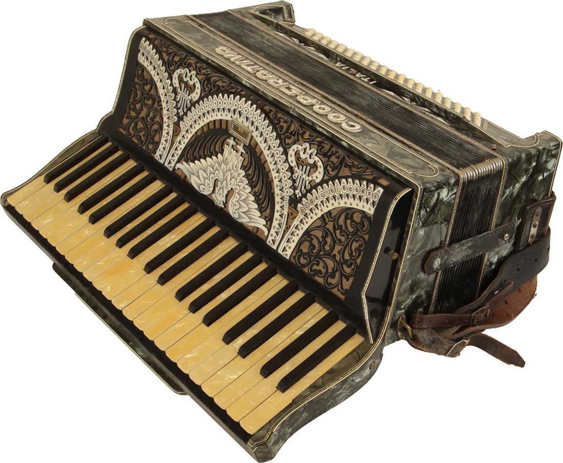 Cooperativa Italia Accordion: 41 keys, 120 bass. Keyboard 19". Grey mother of pearl finish with illustrated grille in white and marbled keys. Comes with leather strap. Made in Italy. Weight 9.8kg. Evidence of repair to bellows: gl