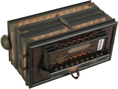 Campbell's Improved Melodion: 10 treble buttons, 2 bass and bell. Ebony finish with colour floral illustrated trim. Weight 1.7kg. Broken cloth strap.