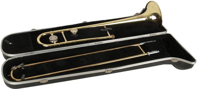 Trombone: Bach model: Gold two piece trombone. Comes with 'The Selmer Company' black hardshell case and Vincent Bach Corp. 12C mouthpiece. Made in USA. Length 46". Weight 1.5". No Visible Damage